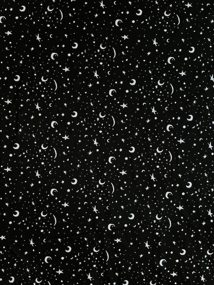 Pattern of stars and moons on a black background